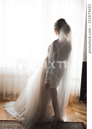 Portrait of beautiful bride with fashion veil at wedding morning Portrait of beautiful bride with fashion veil at wedding morning 101679483