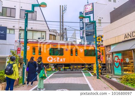 The cityscape of Tokyo in Japan, with a view of the railroad crossing in front of Jiyugaoka Station 101680097