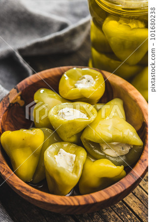 Peppers stuffed with cream cheese in bowl. 101680238