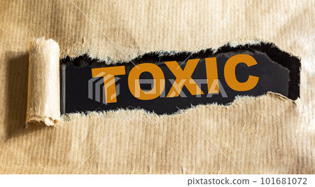 Toxic the word is written on torn brown paper 101681072
