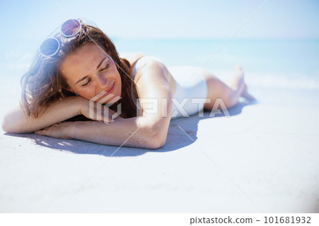 relaxed stylish woman laying at beach 101681932