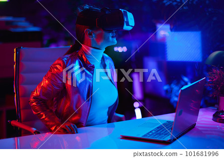 40 years old woman in virtual reality goggles in office 40 years old woman in virtual reality goggles in office 101681996