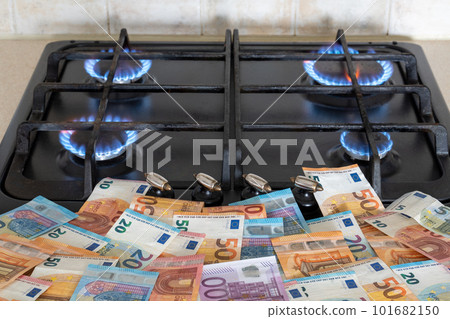 A lot of euro money lying in front of a burning gas stove A lot of euro money lying in front of a burning gas stove 101682150