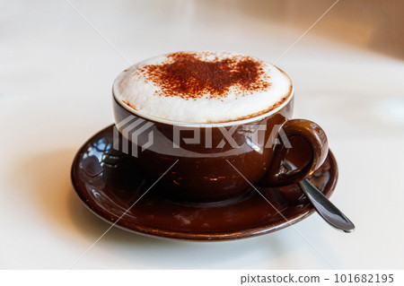 Cup of cappuccino coffee on a table Cup of cappuccino coffee on a table 101682195