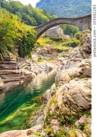 Ancient double arch stone Roman bridge (Ponte dei Salti) over the clear water of the Verzasca river in Lavertezzo ,Verzasca Valley, Ticino Canton, Switzerland Ancient double arch stone Roman bridge (Ponte dei Salti) over the clear water of the Verzasca river in Lavertezzo ,Verzasca Valley, Ticino Canton, Switzerland 101682263