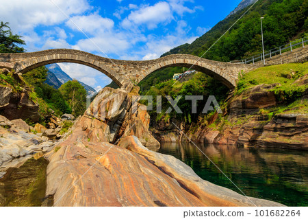 Ancient double arch stone Roman bridge (Ponte dei Salti) over the clear water of the Verzasca river in Lavertezzo ,Verzasca Valley, Ticino Canton, Switzerland 101682264