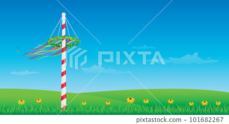 maypole with colorful ribbons on green meadow 101682267