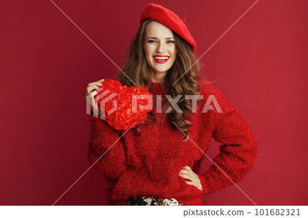 smiling elegant woman in red sweater and beret with red heart 101682321