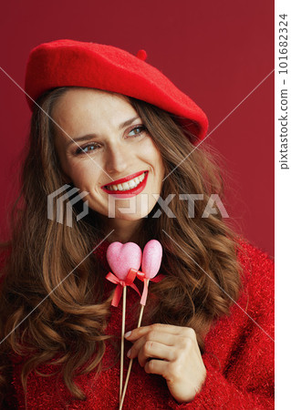 smiling stylish woman in red sweater and beret 101682324