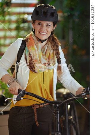 happy stylish business woman in bike helmet in eco office 101682384