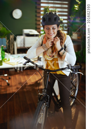 smiling business woman in bike helmet in eco office smiling business woman in bike helmet in eco office 101682393
