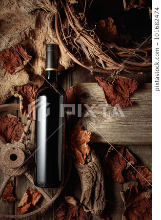 Bottle of red wine on a vintage rustic background. 101682474