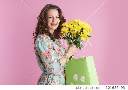 happy modern female with long wavy brunette hair on pink 101682493