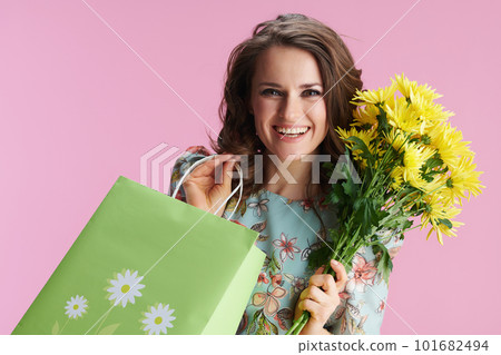 Portrait of happy stylish woman in floral dress on pink Portrait of happy stylish woman in floral dress on pink 101682494