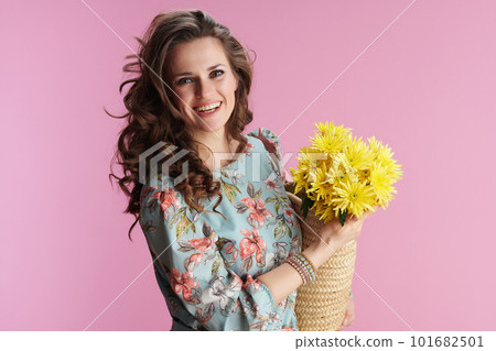 Portrait of smiling modern woman in floral dress on pink Portrait of smiling modern woman in floral dress on pink 101682501