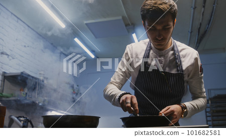 Chef sets fire and fries meat in flambe style Chef sets fire and fries meat in flambe style 101682581