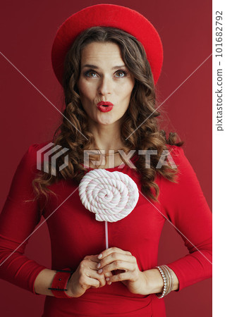 excited elegant woman in red dress and beret on red background excited elegant woman in red dress and beret on red background 101682792