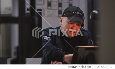 Busy security worker talks with coworker by walkie talkie 101682809