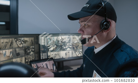 Security operator monitoring CCTV cameras Security operator monitoring CCTV cameras 101682810
