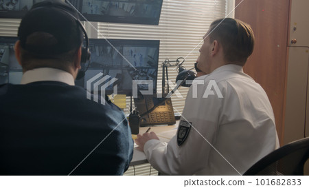 Operator monitors CCTV cameras in observation room Operator monitors CCTV cameras in observation room 101682833