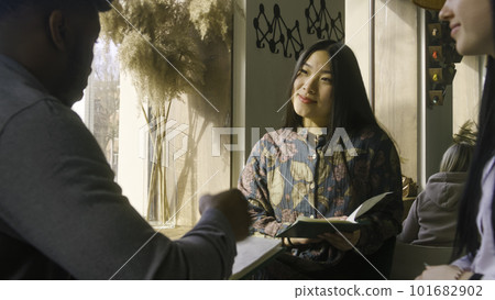 Couple sitting near window and making order Couple sitting near window and making order 101682902
