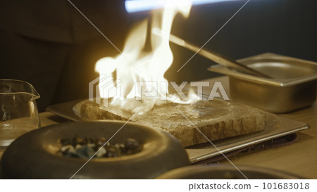 The chef cooks meal in flambe style in modern gastro cafe 101683018