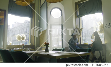 Waitress prepares restaurant with modern design Waitress prepares restaurant with modern design 101683043