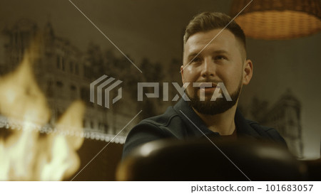 Man looks how chef prepares meal in flambe style Man looks how chef prepares meal in flambe style 101683057