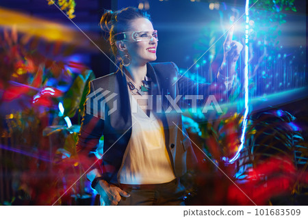 smiling business woman pressing button in air in metaverse smiling business woman pressing button in air in metaverse 101683509