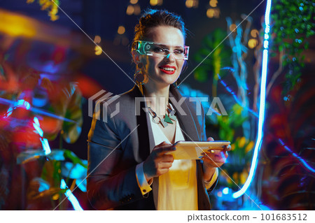 Portrait of happy business woman using tablet PC in metaverse Portrait of happy business woman using tablet PC in metaverse 101683512
