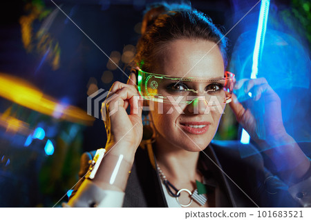 happy modern female with futuristic goggles in virtual reality 101683521