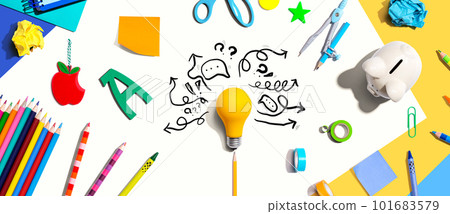 Brainstorming concept with a light bulb and school supplies 101683579