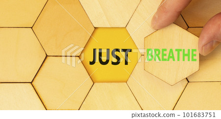 Just breathe and psychological symbol. Concept words Just breathe on wooden puzzles. Beautiful yellow table yellow background. Businessman hand. Business psychological Just breathe concept. Copy space 101683751