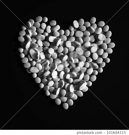 Heart made of white pills on black background. Medicine and vitamins in the shape of heart artistic illustration. Decorative ai generated poster with food supplements. 101684315