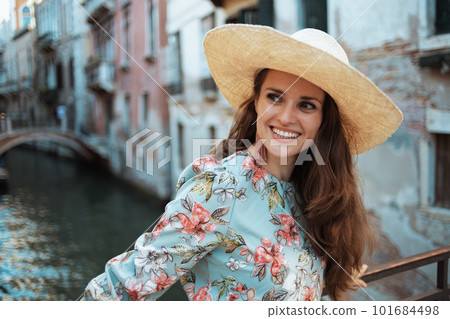 happy solo tourist woman in floral dress enjoying promenade happy solo tourist woman in floral dress enjoying promenade 101684498