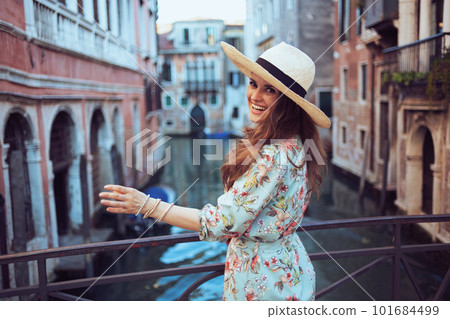 happy stylish woman in floral dress enjoying promenade happy stylish woman in floral dress enjoying promenade 101684499