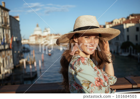 Portrait of happy elegant woman in floral dress with hat 101684503