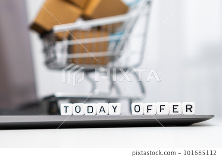 Today offer words on cubes with a toy shopping cart and cardboard boxes in the background. Online shopping concept. Today offer words on cubes with a toy shopping cart and cardboard boxes in the background. Online shopping concept. 101685112