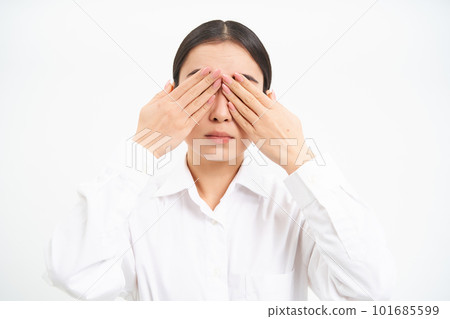 Asian woman entrepreneur, businesswoman shuts her eyes with hands, stands blindfolded against white studio background Asian woman entrepreneur, businesswoman shuts her eyes with hands, stands blindfolded against white studio background 101685599