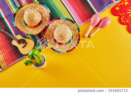 Cinco de Mayo holiday background. Maracas, cactus and hat on yellow background. 101685715