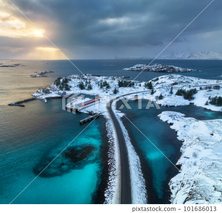 Aerial view of road, island in snow, rorbu, sea, bridge 101686013