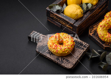 Delicious fresh donuts in yellow glaze with lemon flavor filling Delicious fresh donuts in yellow glaze with lemon flavor filling 101686954