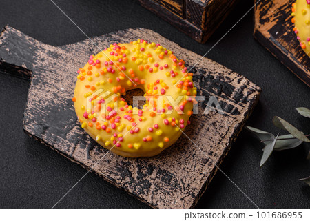 Delicious fresh donuts in yellow glaze with lemon flavor filling 101686955