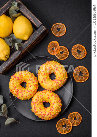 Delicious fresh donuts in yellow glaze with lemon flavor filling Delicious fresh donuts in yellow glaze with lemon flavor filling 101686964