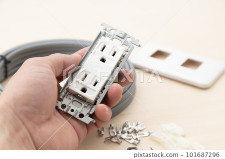 Hand holding an outlet 101687296