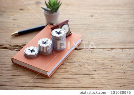 Money piled up on a book (yen) Money piled up on a book (yen) 101688976
