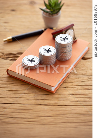 Money piled up on a book (yen) Money piled up on a book (yen) 101688978