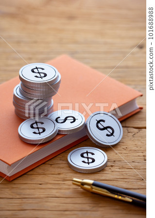 Money (dollars) piled up on a book 101688988