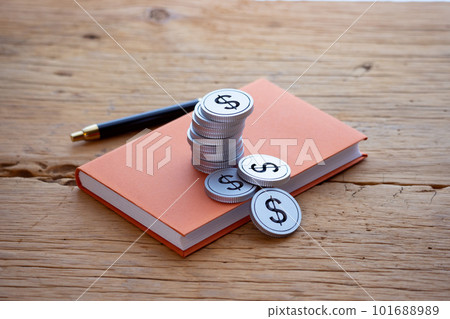 Money (dollars) piled up on a book 101688989