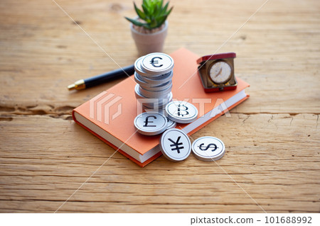 Money piled up on a book (foreign exchange) 101688992